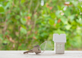  House key on a house shaped keychain. Real estate concept