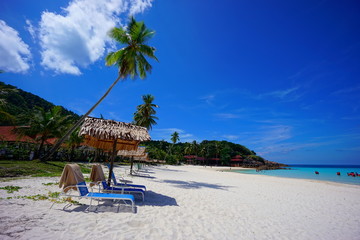 Beach chair with umbrella with blue sky on tropical beach