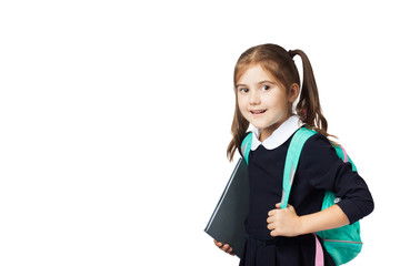 Portrait of a little cute girl with a backpack and books in the school uniform going to school....