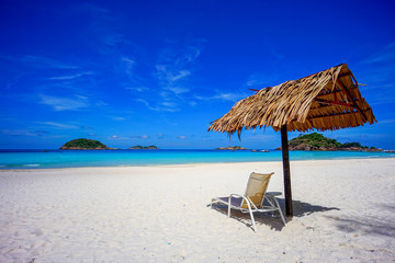 Beach chair with umbrella with blue sky on tropical beach