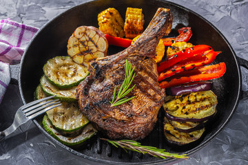 Juicy steak and grilled vegetables in a pan. Life style.