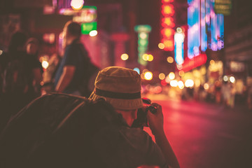 Abstract blurred photographer taking photos, night traffic bokeh, Walking Street, city street by...