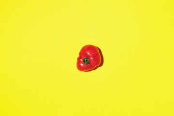 Fototapeta premium Red tomato on yellow background with copy space. Top view. Flat lay. Summer minimal concept. Vegan and vegetarian diet