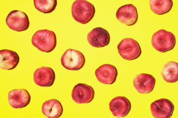 Peaches pattern on pastel yellow background. Frame made of fresh fruits. Flat lay, top view, copy space. Vegan and vegetarian diet