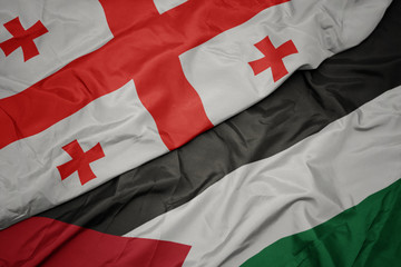 Fototapeta premium waving colorful flag of palestine and national flag of georgia.