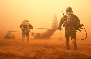 Military troops and helicopter on the way to the battlefield / Between sand storm in desert