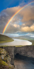 portrait frame panorama of rainbow and lake above sea bay on Faroe island. Big size.