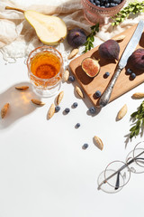 Figs, pear and blueberries on a cutting wooden board.