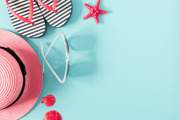 Summer beach composition. Beach pink accessories, straw hat, sunglasses, flip flop, starfish on...