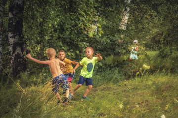 Naklejka na ściany i meble Boys fighting over girls outdoors in forest countryside childhood lifestyle