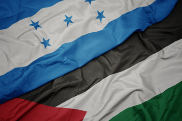 waving colorful flag of palestine and national flag of honduras.