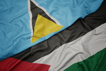 waving colorful flag of palestine and national flag of saint lucia.