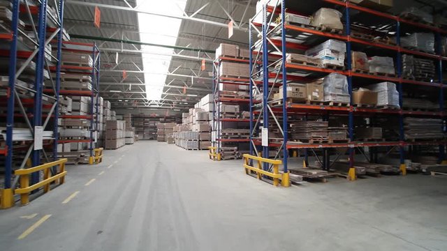 View of the storage with parquet at the factory from the inside. Business. Camera motion to around.