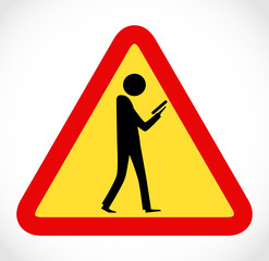 Danger on road sign concept - man with mobile phone walking through crossroad