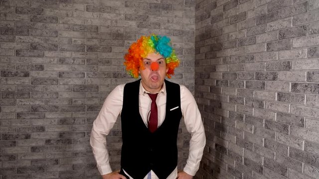Office worker in clown wig, clown concept at work. Businessman with clown wig. Original clown costume for Halloween