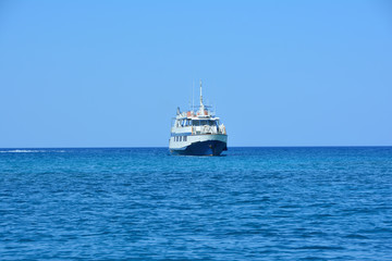 pleasure ship at sea against a clear summer sky