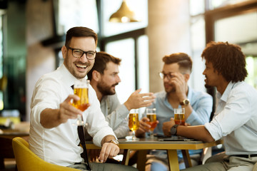 portrait of a young guy holding a glass of beer in his hand