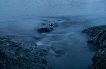 Waves hitting rocks with long exposure