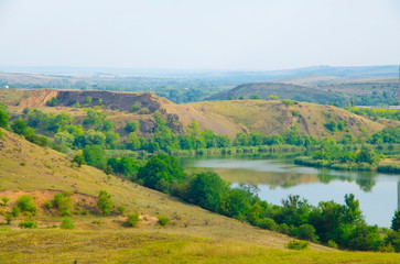 Fototapeta na wymiar Part of the Shterovskoye reservoir on the background of the rock mass of the Donetsk Ridge.