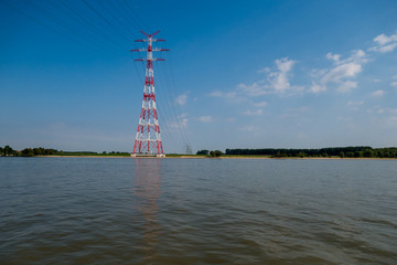 View from ship at electricity pylons named Elbecrossing at day.