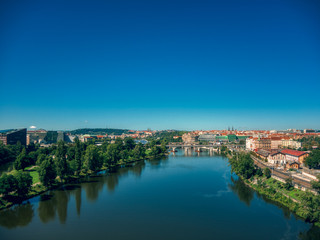 Fototapeta premium aerial flight over vltava river next to bridges sunny day of summer in Prague