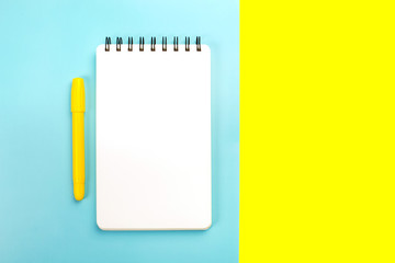 School supplies on yellow and pink background with copy space. Back to school concept.