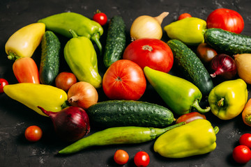 Vegetables on a dark wooden background. Place for text