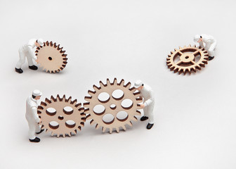 Little people doll with gears. Formation of new contacts.