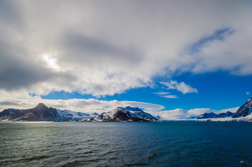 Glacier heading down from a mountain range into the Arctic Ocean, Hornsund, Norway