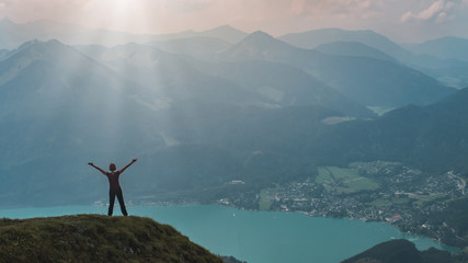 Young woman happy on top of the mountain