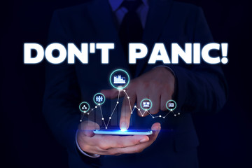 Writing note showing Don T Panic. Business concept for suddenly feel so worried or frightened that you can not behave Male wear formal suit presenting presentation smart device