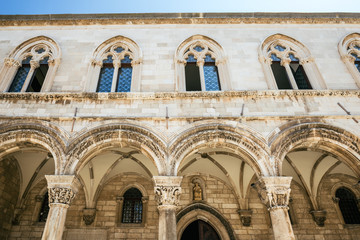 Fototapeta na wymiar Fragment of the Sponza palace and the Cathedral on the square in the old town of Dubrovnik, Croatia