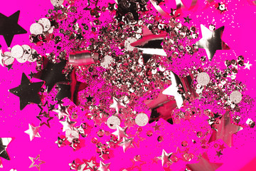 Silver sparkles on pink background. Holiday concept.