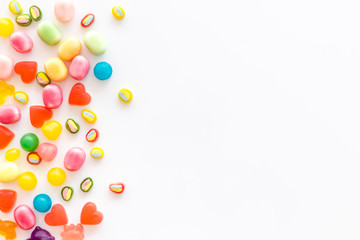 Assorted sweets and marmalade on white background top view space for text