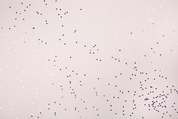 Little purple stars on grey background. Festive concept.