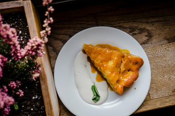 Slice of fall pumpkin pie with cream