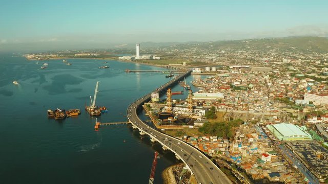 Suburb of Cebu City with roads and cars, residential buildings and the port. Philippines, Cebu