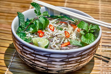 Traditional Vietnamese soup, Pho Bo in a large bowl.