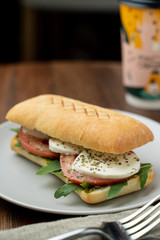 Grilled caprese ciabatta with tomatoes, pasta sauce and mozzarella, served with a cup of coffee