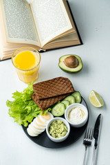 Crunchy rye toasts with fresh lettuce, hard boiled eggs, cream cheese, guacamole and cucumber with fresh pulpy orange juice - a perfect combo for slow breakfast