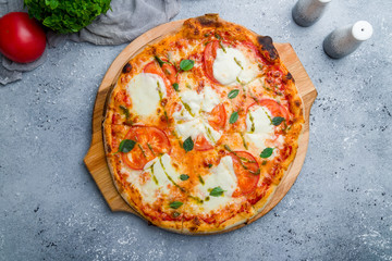 Italian pizza Margherita buffalo with tomatoes, mozzarella and basil on beautiful grey table