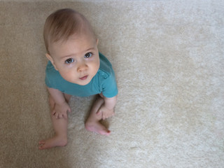 Portrait of a sweet little baby boy looking up with beautiful and innocent eyes