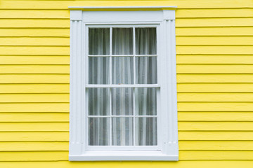 Old Window with Yellow Siding