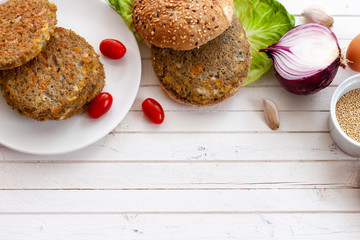 quinoa vegetable burger with tomato and onion