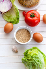 quinoa vegetable burger with quinoa bowl, tomato, eggs and onion