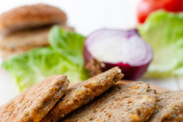 quinoa vegetable burger with tomato and onion