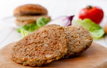 quinoa vegetable burger with  tomato and onion
