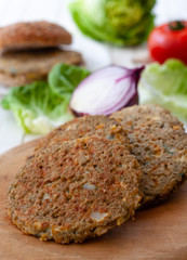 quinoa vegetable burger with tomato and onion