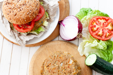 quinoa vegetable burger with tomato and onion
