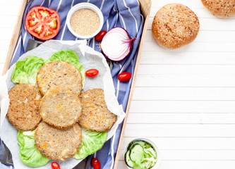 quinoa vegetable burger with quinoa bowl, tomato and onion